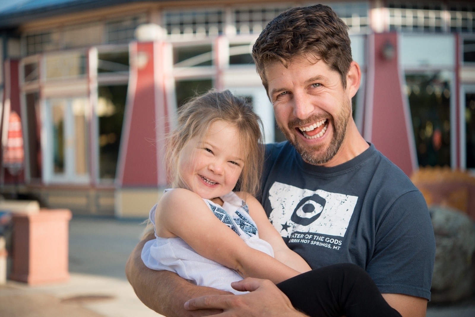 Father hold smiling little girl