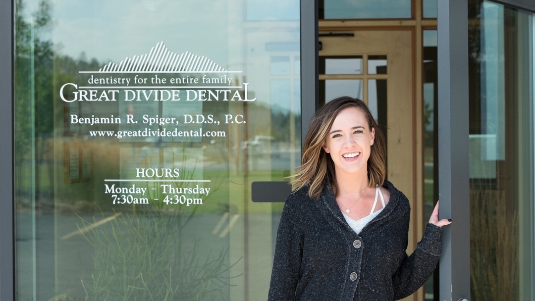 Smiling woman leaving Great Divide Dental